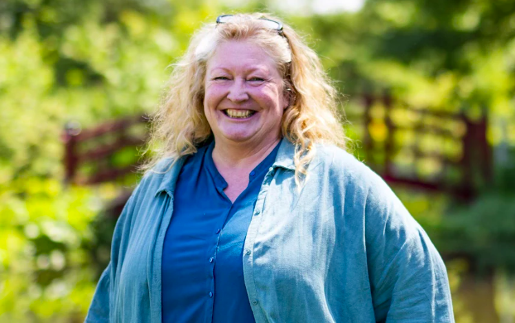 Photograph of TV Gardener, Charlie Dimmock in a blue Cardigan and dark blue shirt